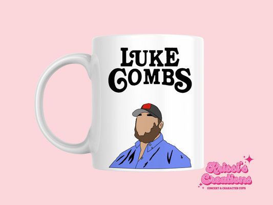A white ceramic mug with a drawing of a Luke Combs, above it is the text Luke Combs on the front. This is a 10oz mug which is perfect for fans of Luke Combs. Made and sold by Krissi's Creations.