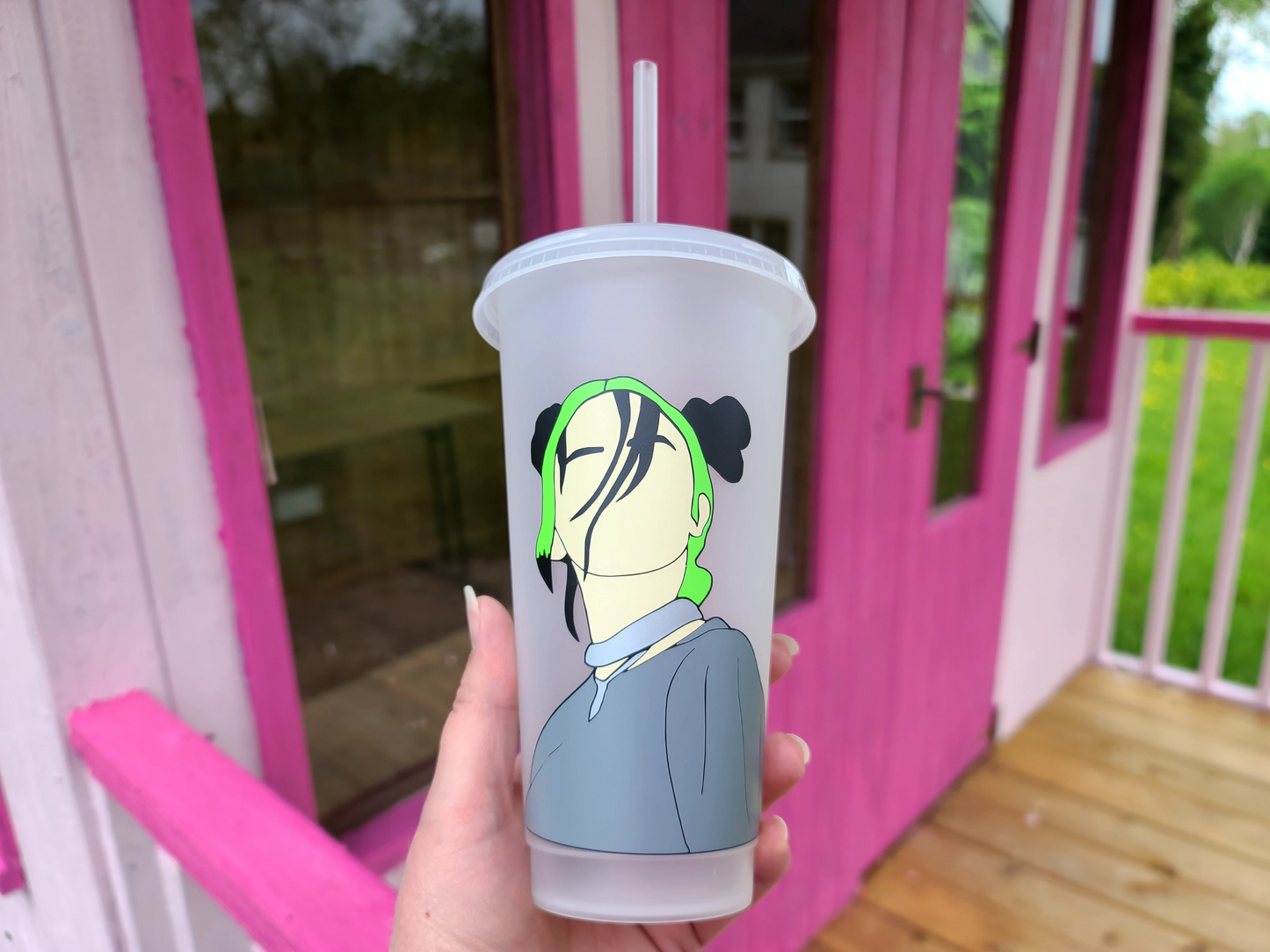 A frosted tumbler with a drawing of Billie Eilish. This is a 24oz cup which is perfect for fans of Billie Eilish. Made and sold by Krissi's Creations.