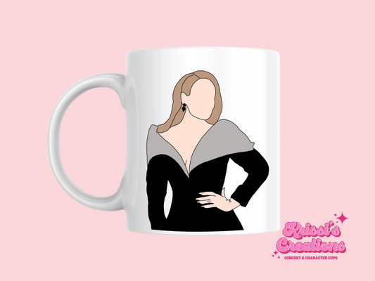 A white ceramic mug with a drawing of Adele on the front. This is a 10oz mug which is perfect for fans of Adele Vegas Residency Concerts. Made and sold by Krissi's Creations.