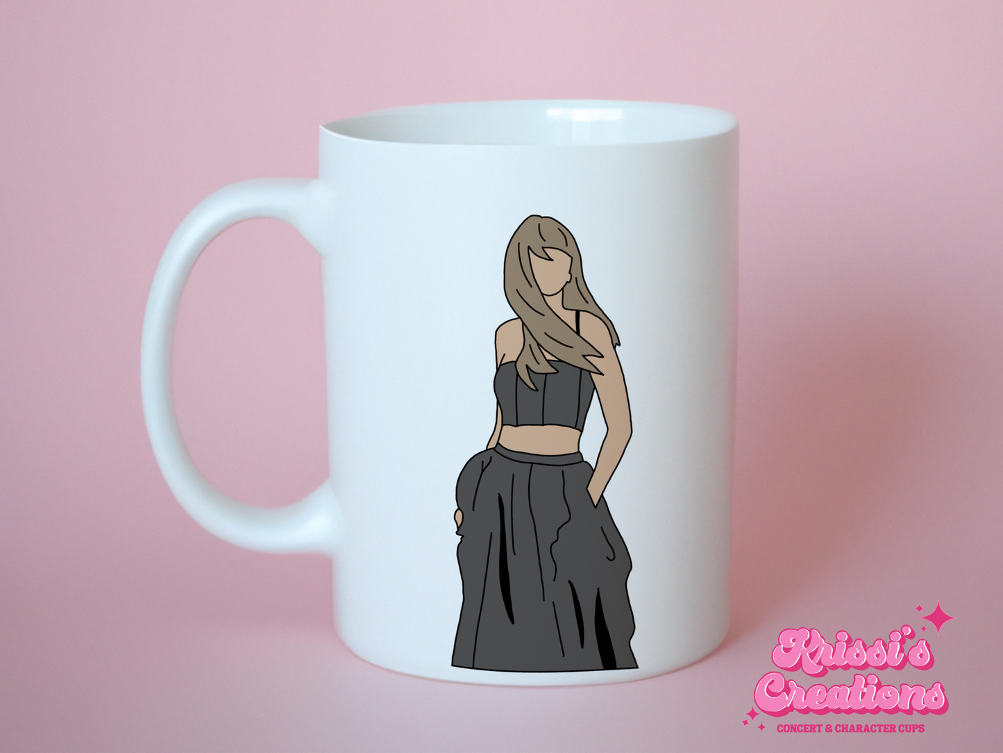 A white ceramic mug with a drawing of Taylor Swift from her Tortured Poets Department Era on the front. This is a 10oz mug which is perfect for fans of Era's Tour, particularly the TTPD Album. Made and sold by Krissi's Creations.