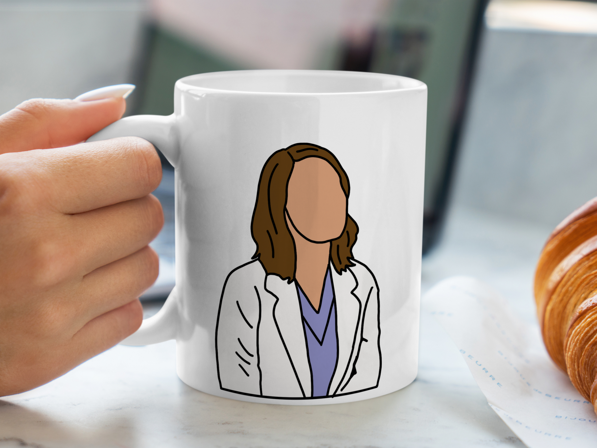 A white ceramic mug with a drawing of Jo Wilson from Grey's Anatomy on the front. This is a 10oz mug which is perfect for fans of Grey's Anatomy, particularly the character Jo Wilson. Made and sold by Krissi's Creations.