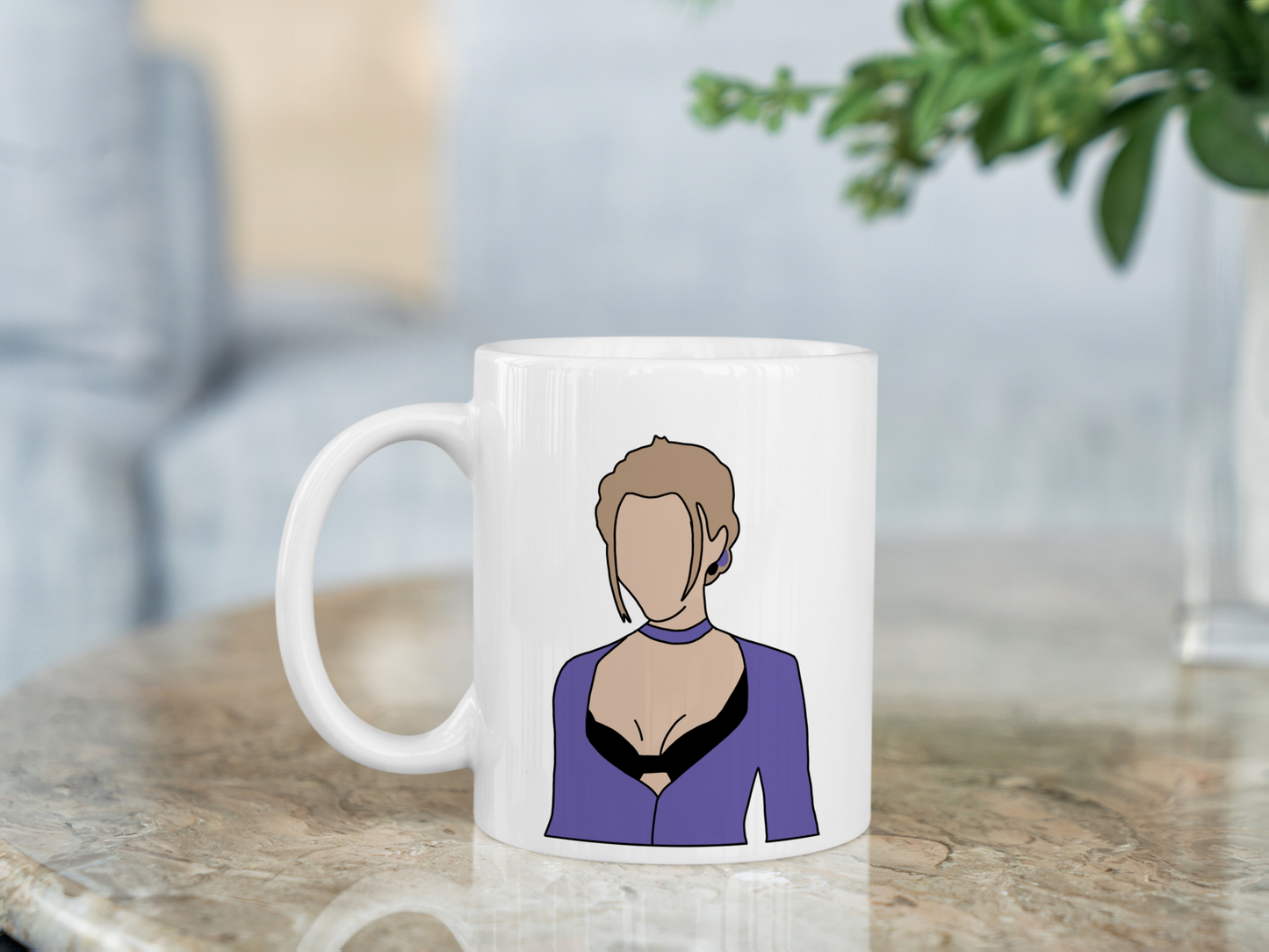 A white ceramic mug with a drawing of Phoebe Buffay from Friends on the front. This is a 10oz mug which is perfect for fans of Friends, particularly the character Phoebe. Made and sold by Krissi's Creations.