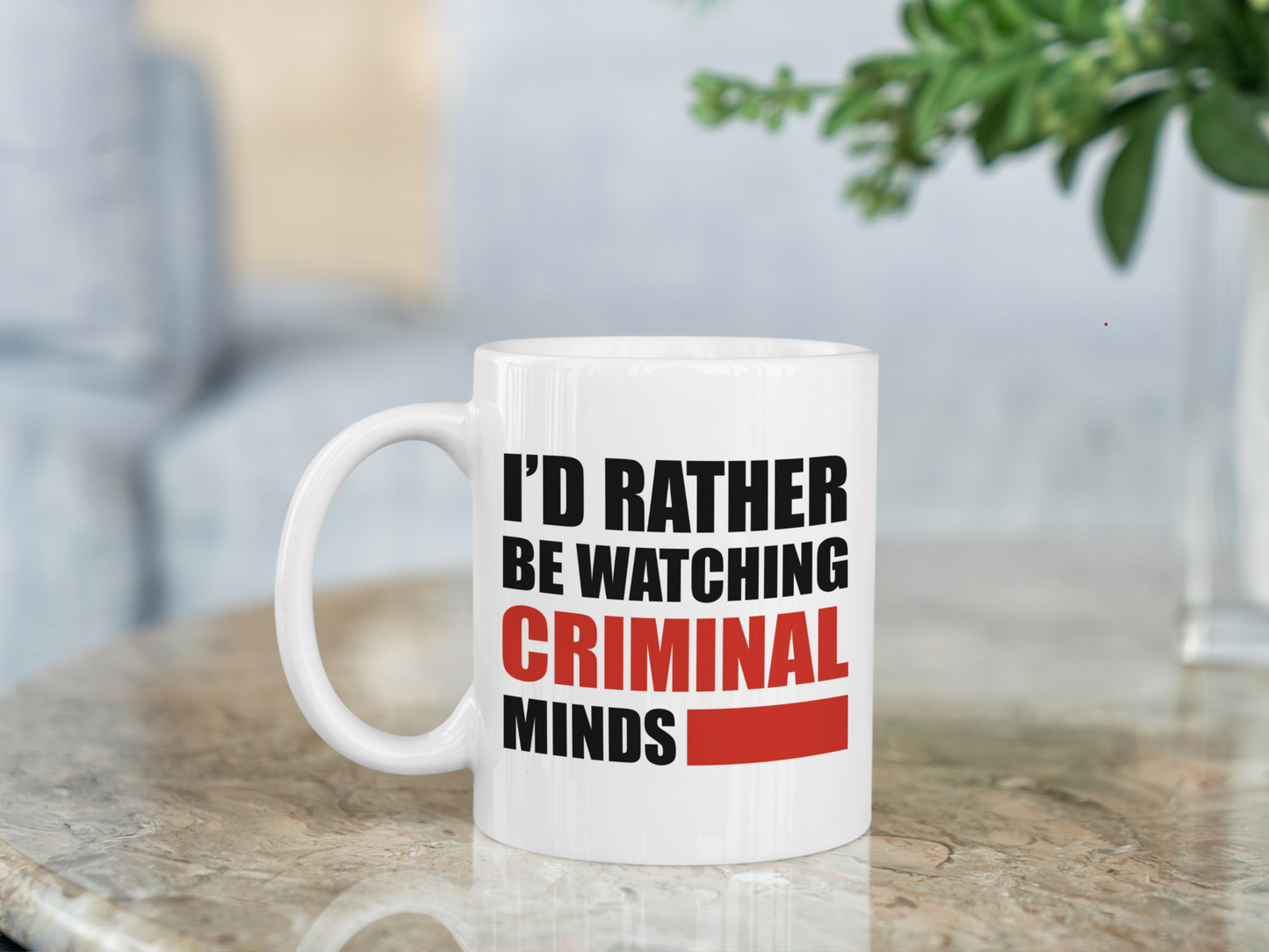 A white ceramic mug with the text I'd rather be watching Criminal Minds on the front. This is a 10oz mug which is perfect for fans of the series Criminal Minds. Made and sold by Krissi's Creations.