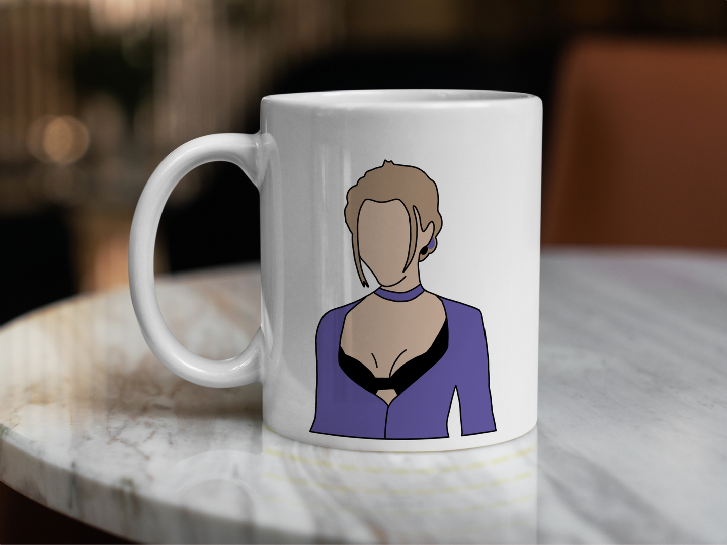 A white ceramic mug with a drawing of Phoebe Buffay from Friends on the front. This is a 10oz mug which is perfect for fans of Friends, particularly the character Phoebe. Made and sold by Krissi's Creations.