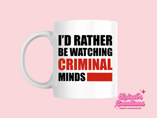 A white ceramic mug with the text I'd rather be watching Criminal Minds on the front. This is a 10oz mug which is perfect for fans of the series Criminal Minds. Made and sold by Krissi's Creations.