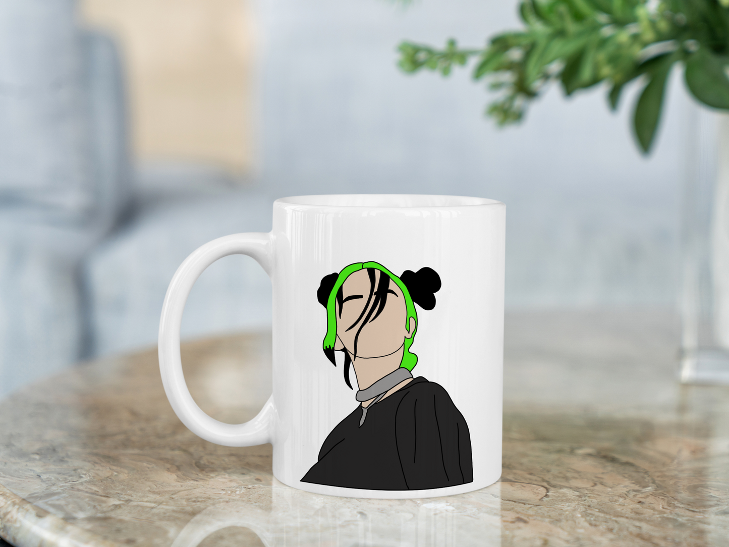 A white ceramic mug with a drawing of Billie Eilish with her Green and black hair on the front. This is a 10oz mug which is perfect for fans of Billie Eilish, particularly her Concerts. Made and sold by Krissi's Creations.