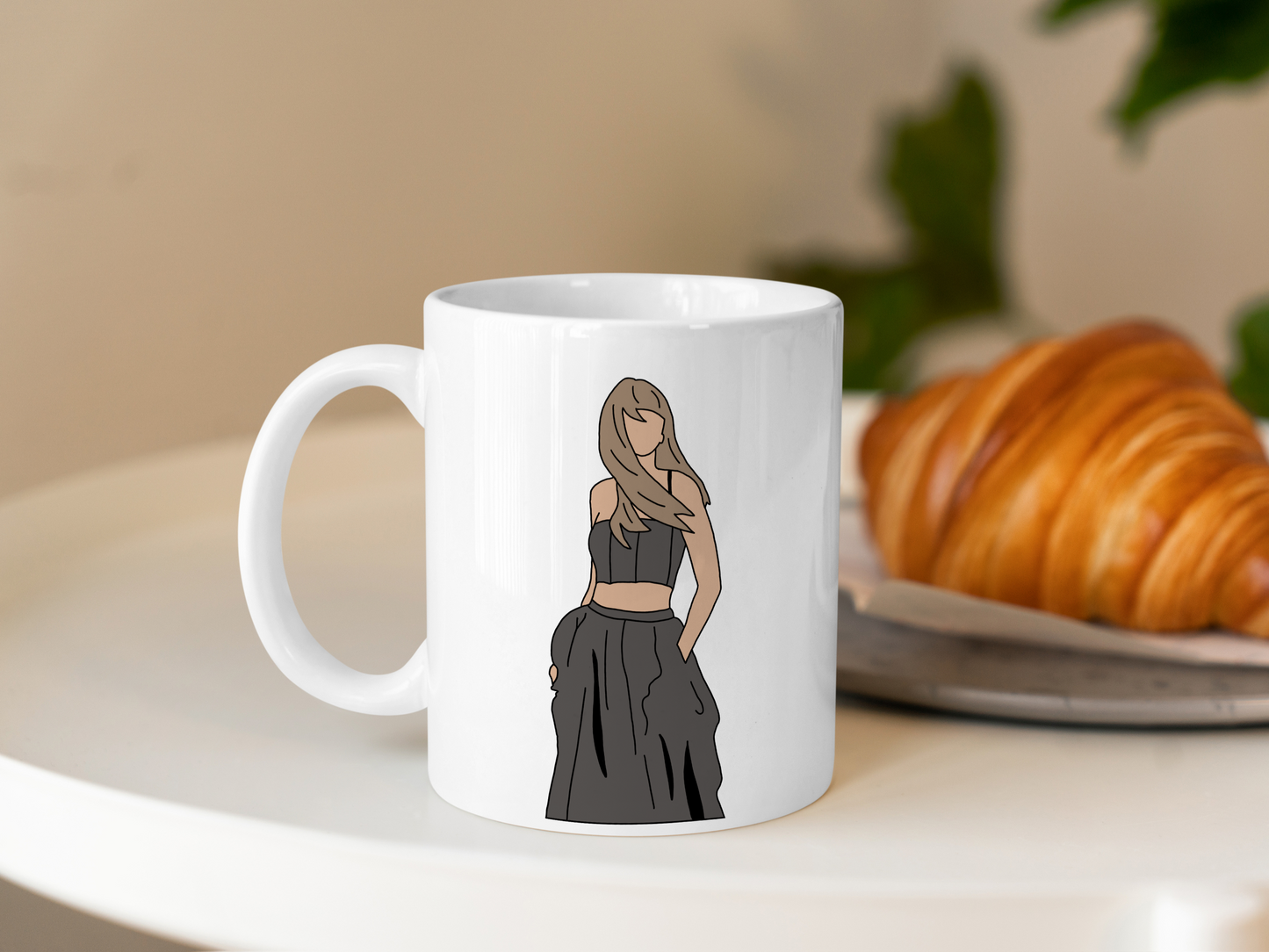 A white ceramic mug with a drawing of Taylor Swift from her Tortured Poets Department Era on the front. This is a 10oz mug which is perfect for fans of Era's Tour, particularly the TTPD Album. Made and sold by Krissi's Creations.