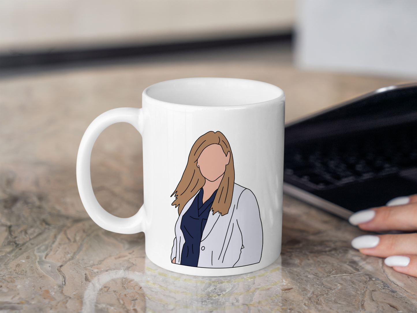 A white ceramic mug with a drawing of Arizona Robbins from Grey's Anatomy on the front. This is a 10oz mug which is perfect for fans of Grey's Anatomy, particularly the character Arizona Robbins. Made and sold by Krissi's Creations.