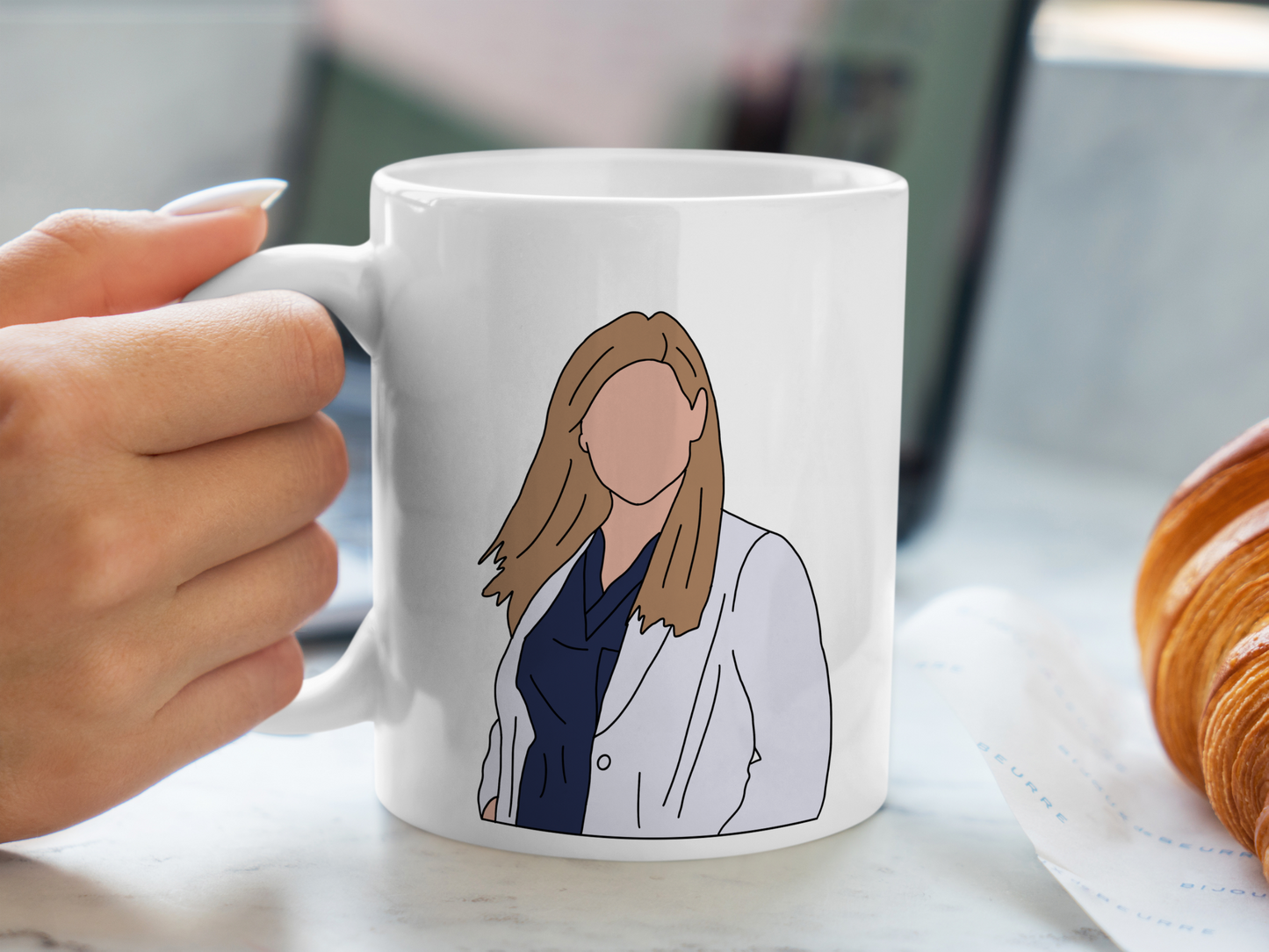 A white ceramic mug with a drawing of Arizona Robbins from Grey's Anatomy on the front. This is a 10oz mug which is perfect for fans of Grey's Anatomy, particularly the character Arizona Robbins. Made and sold by Krissi's Creations.