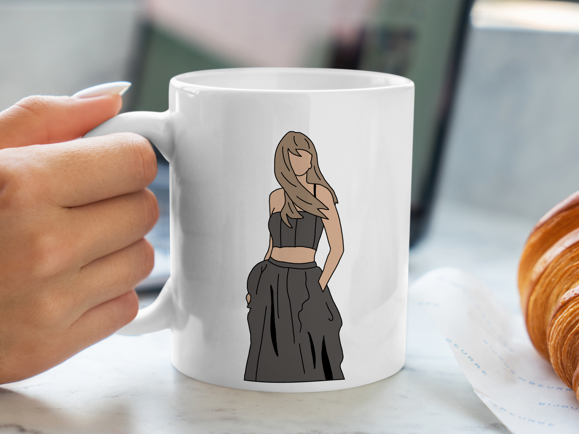 A white ceramic mug with a drawing of Taylor Swift from her Tortured Poets Department Era on the front. This is a 10oz mug which is perfect for fans of Era's Tour, particularly the TTPD Album. Made and sold by Krissi's Creations.