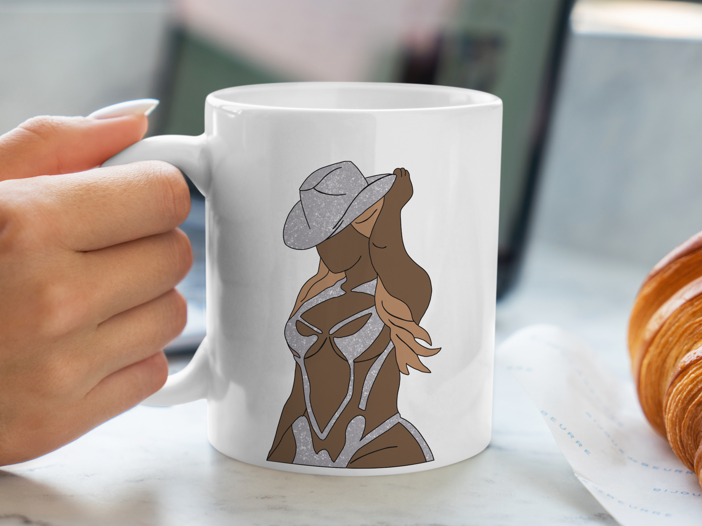 A white ceramic mug with a drawing of Beyonce on the front. This is a 10oz mug which is perfect for fans of Beyonce Renaissance Tour Concerts. Made and sold by Krissi's Creations.