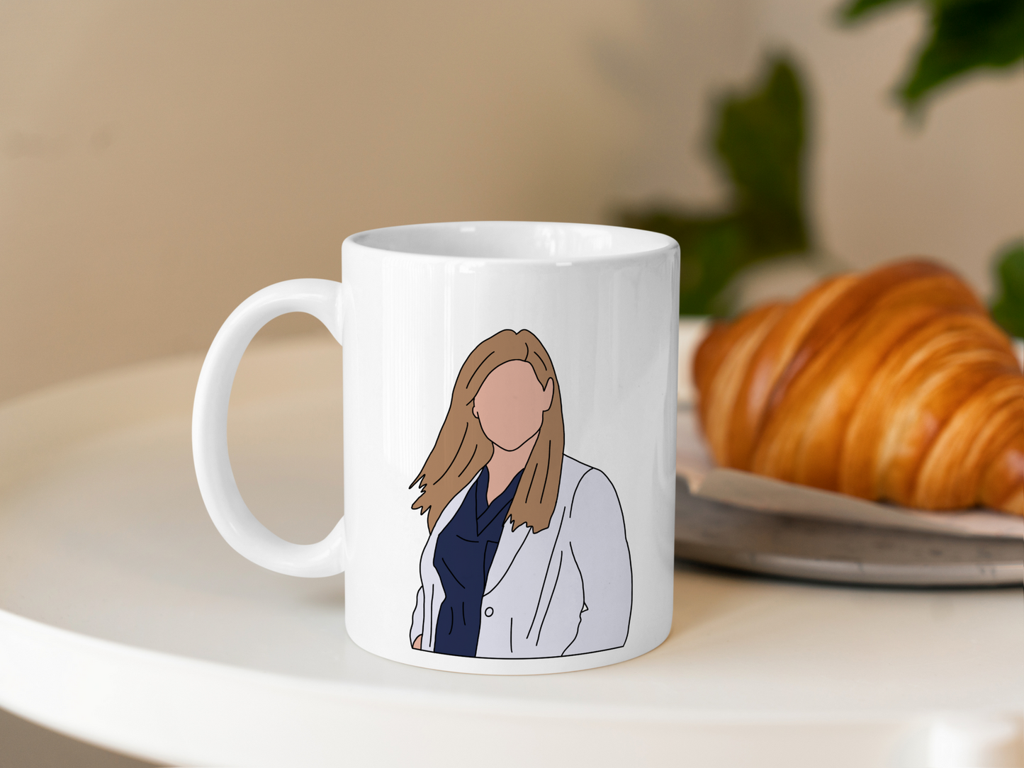 A white ceramic mug with a drawing of Arizona Robbins from Grey's Anatomy on the front. This is a 10oz mug which is perfect for fans of Grey's Anatomy, particularly the character Arizona Robbins. Made and sold by Krissi's Creations.