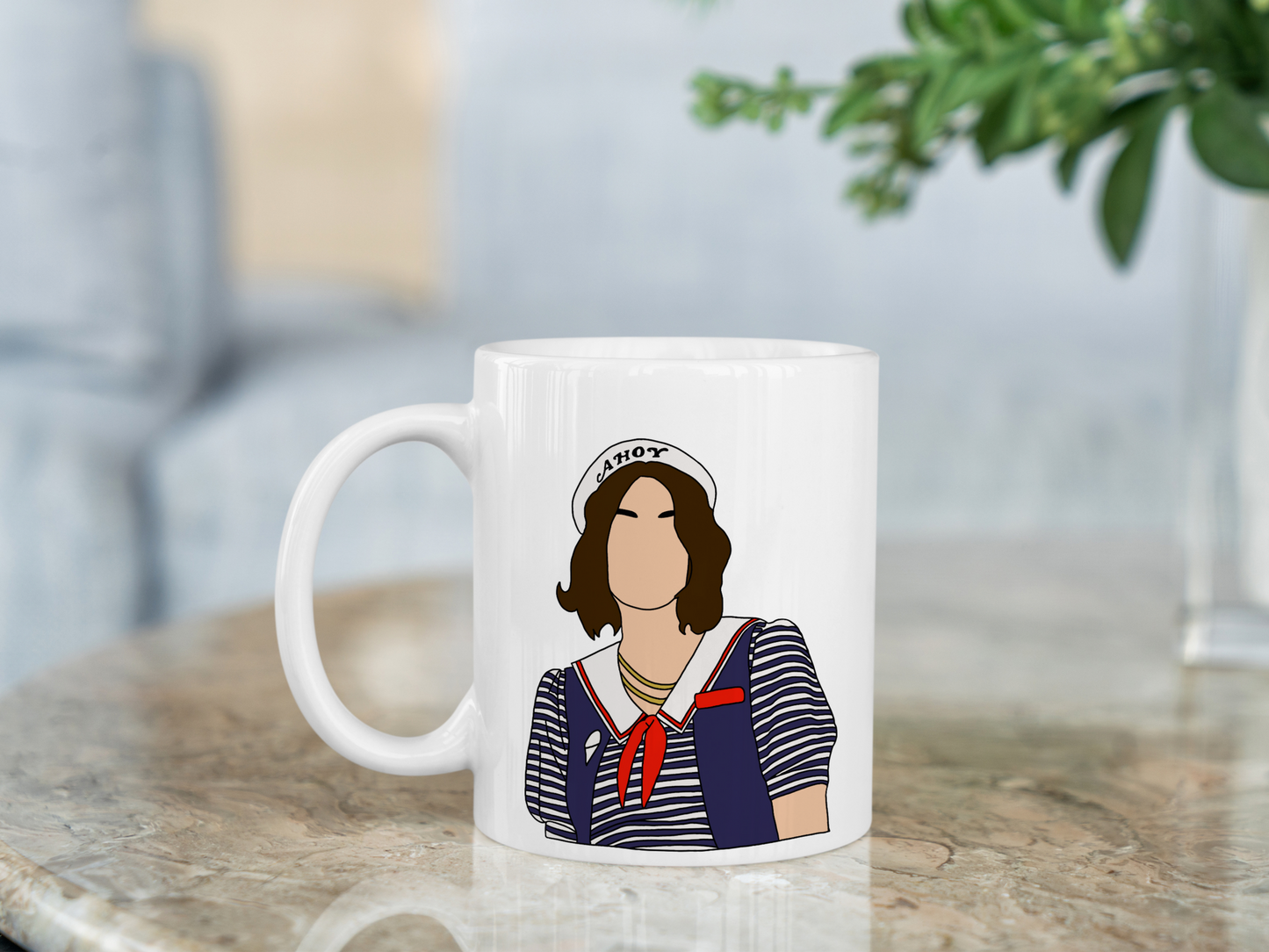 A white ceramic mug with a drawing of Robin Buckley from Stranger Things on the front. This is a 10oz mug which is perfect for fans of Stranger Things, particularly the character Robin Buckley. Made and sold by Krissi's Creations.