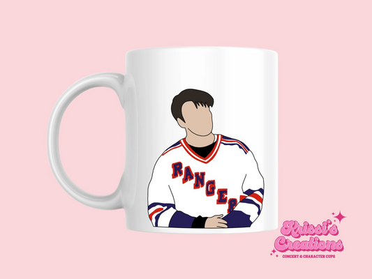 A white ceramic mug with a drawing of Joey Tribbiani from Friends on the front. This is a 10oz mug which is perfect for fans of Friends, particularly the character Joey. Made and sold by Krissi's Creations.