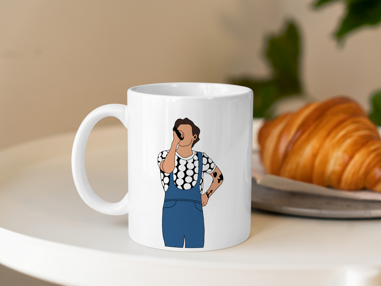 A white ceramic mug with a drawing of Harry Styles Manchester Love On Tour Outfit on the front. This is a 10oz mug which is perfect for fans of Harry Styles Love on Tour Concert. Made and sold by Krissi's Creations.