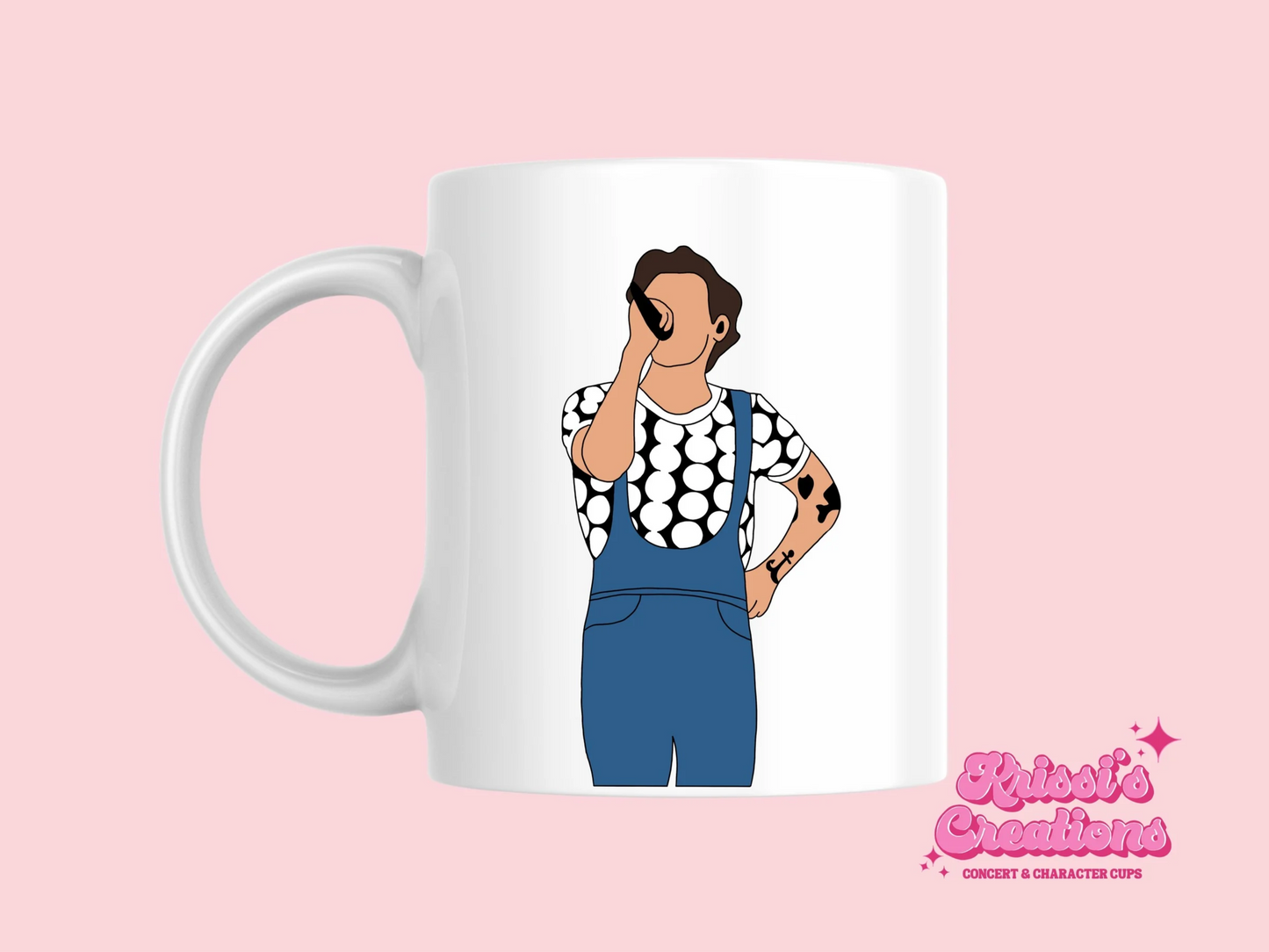 A white ceramic mug with a drawing of Harry Styles Manchester Love On Tour Outfit on the front. This is a 10oz mug which is perfect for fans of Harry Styles Love on Tour Concert. Made and sold by Krissi's Creations.