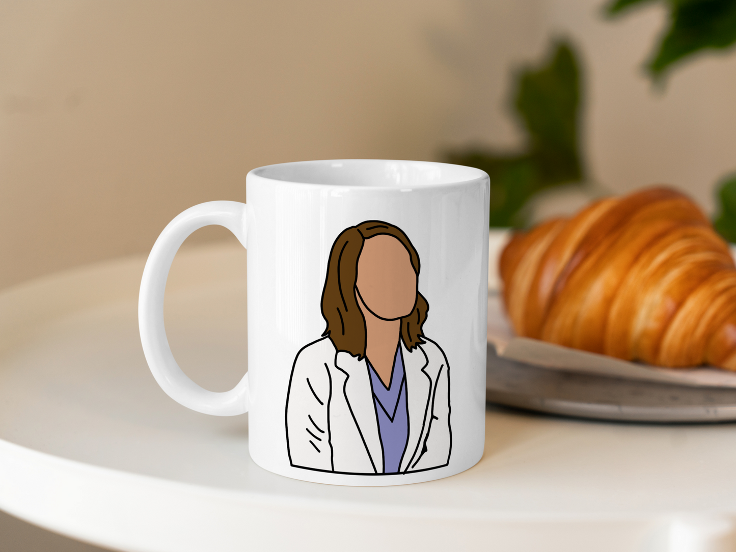 A white ceramic mug with a drawing of Jo Wilson from Grey's Anatomy on the front. This is a 10oz mug which is perfect for fans of Grey's Anatomy, particularly the character Jo Wilson. Made and sold by Krissi's Creations.