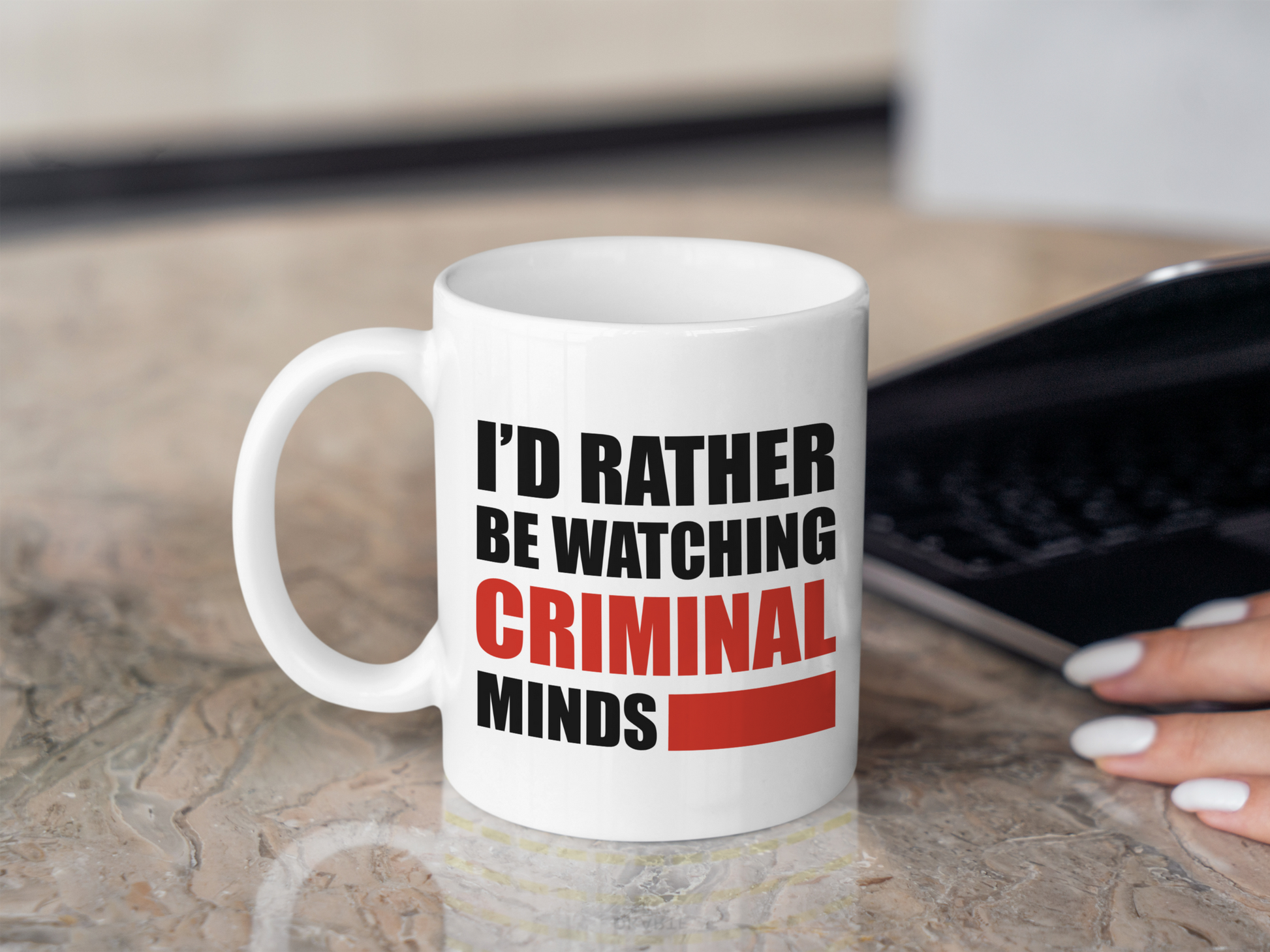 A white ceramic mug with the text I'd rather be watching Criminal Minds on the front. This is a 10oz mug which is perfect for fans of the series Criminal Minds. Made and sold by Krissi's Creations.