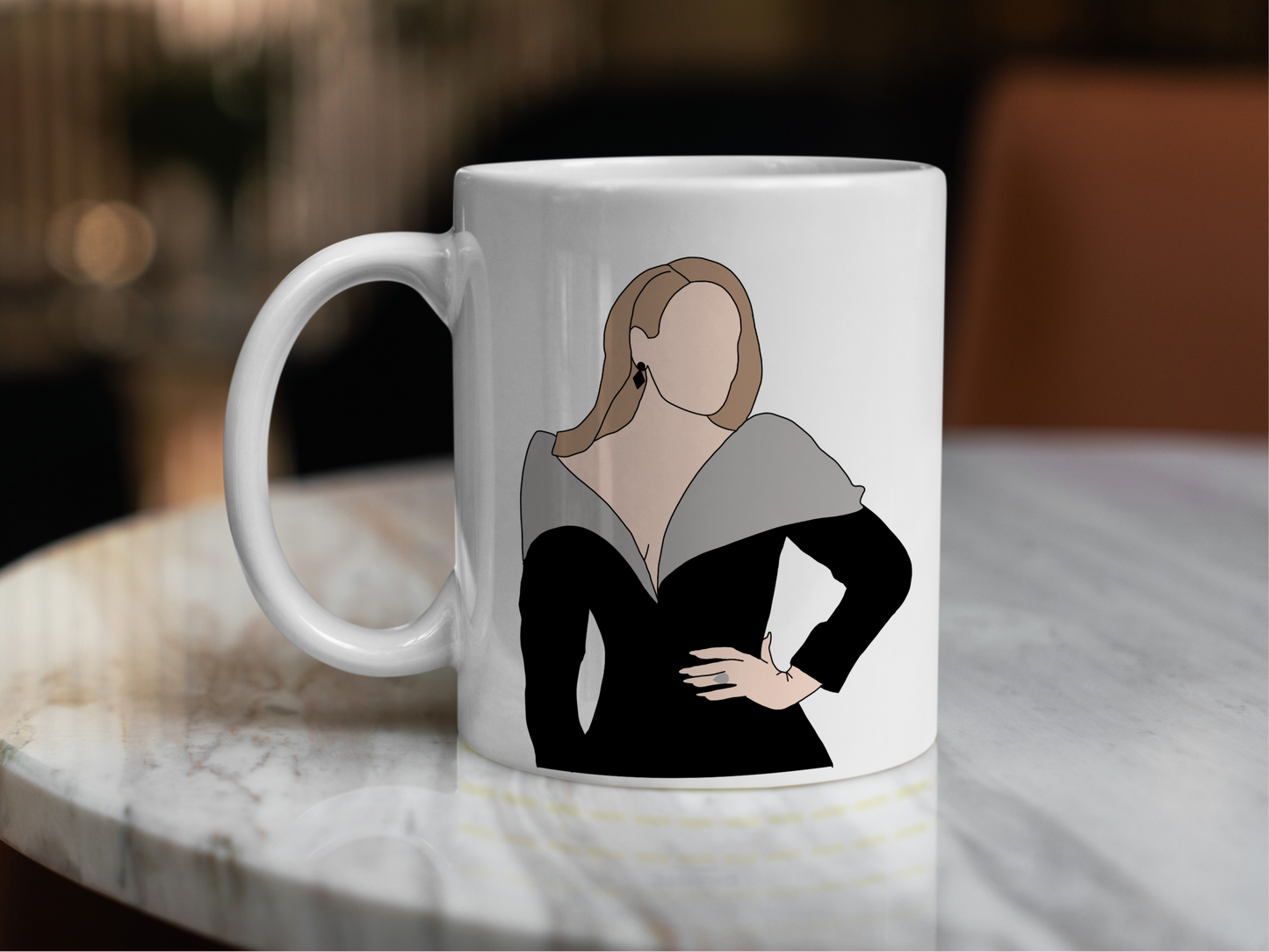 A white ceramic mug with a drawing of Adele on the front. This is a 10oz mug which is perfect for fans of Adele Vegas Residency Concerts. Made and sold by Krissi's Creations.