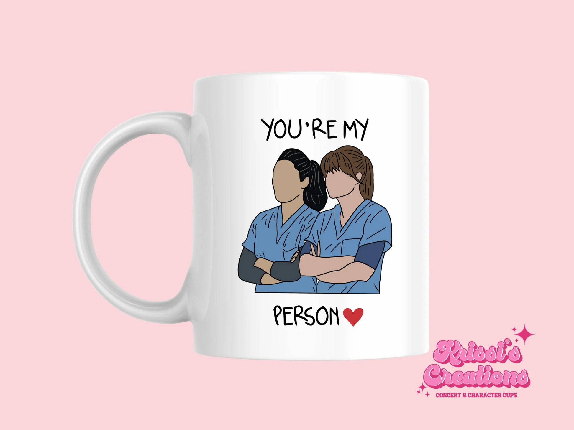 A white ceramic mug with a drawing of Meredith Grey and Cristina Yang from Grey's Anatomy on the front with the text You're my person. This is a 10oz mug which is perfect for fans of Grey's Anatomy, particularly the characters Meredith Grey and Cristina Yang. Made and sold by Krissi's Creations.