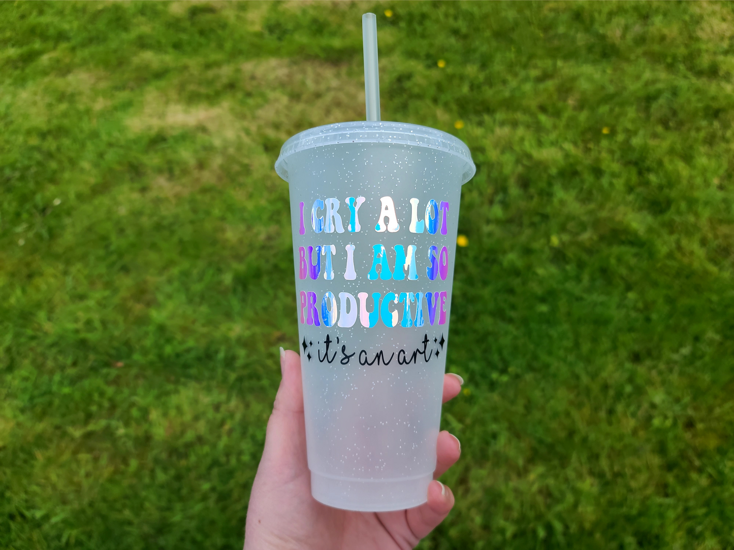 A Glitter tumbler with The Text I Cry A Lot But I am So Productive Lyrics From The Tortured Poets Department TTPD. This is a 24oz cup which is perfect for fans of Taylor Swift. Made and sold by Krissi's Creations.