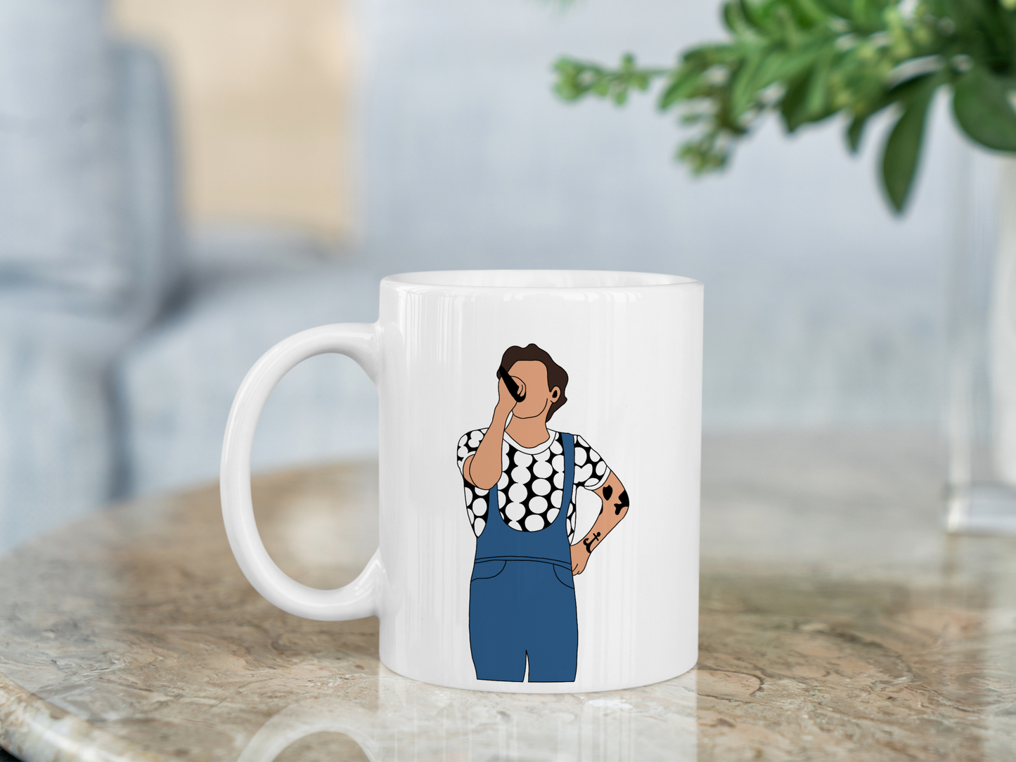 A white ceramic mug with a drawing of Harry Styles Manchester Love On Tour Outfit on the front. This is a 10oz mug which is perfect for fans of Harry Styles Love on Tour Concert. Made and sold by Krissi's Creations.