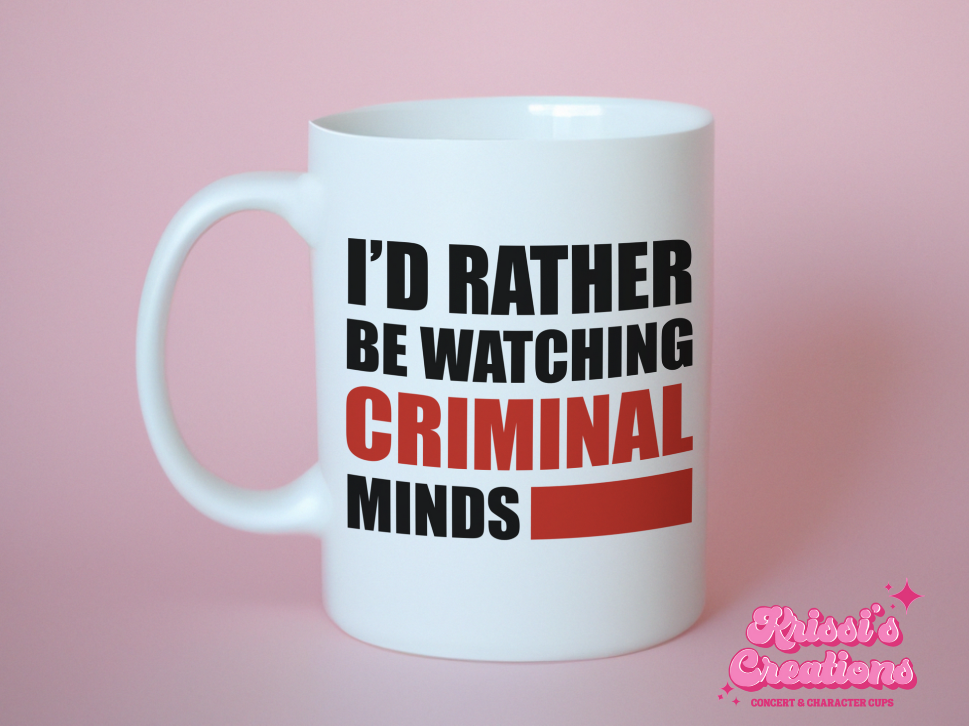 A white ceramic mug with the text I'd rather be watching Criminal Minds on the front. This is a 10oz mug which is perfect for fans of the series Criminal Minds. Made and sold by Krissi's Creations.